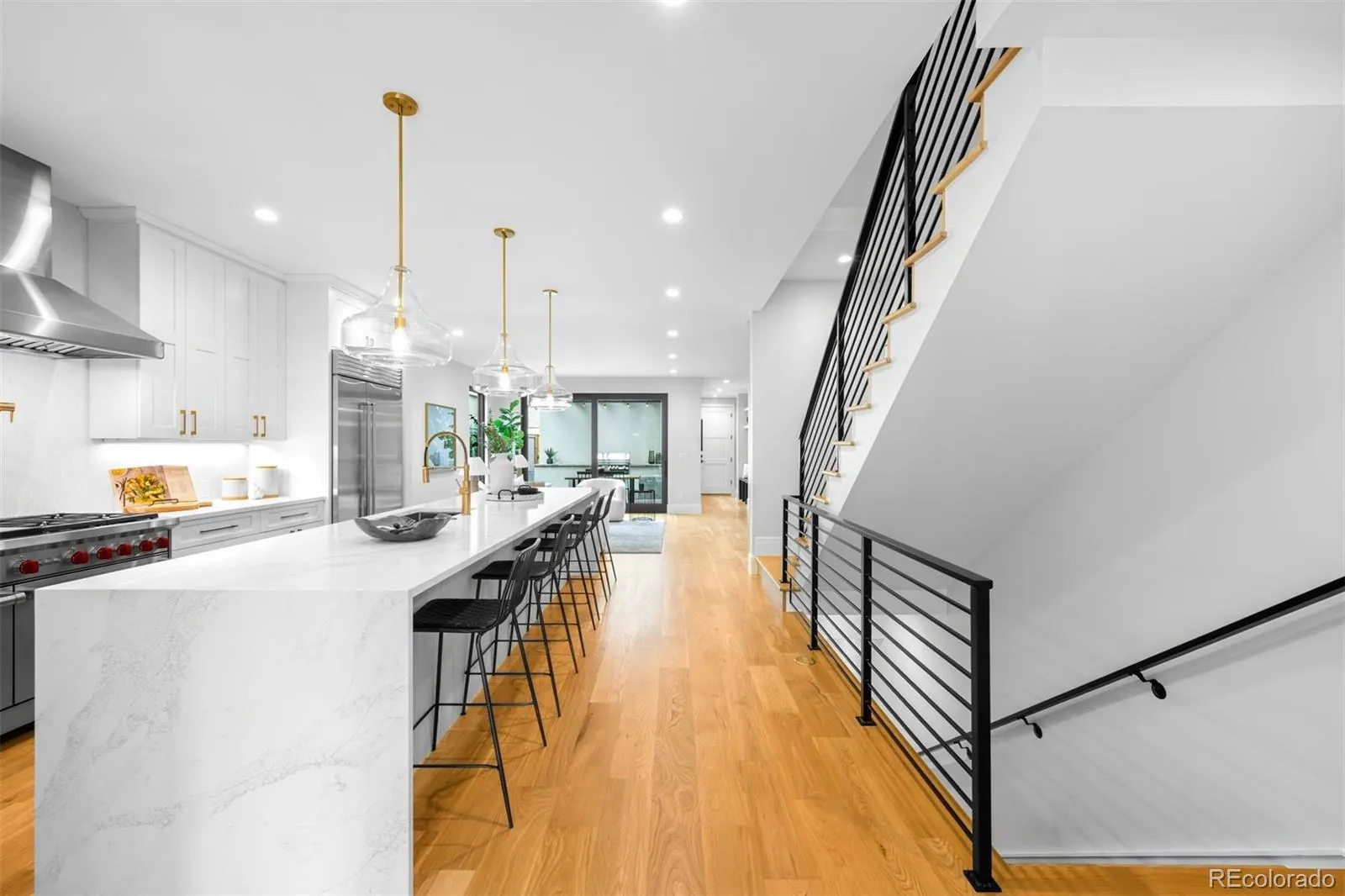 Kitchen with a long marble island and an open staircase at 340 Jackson Street