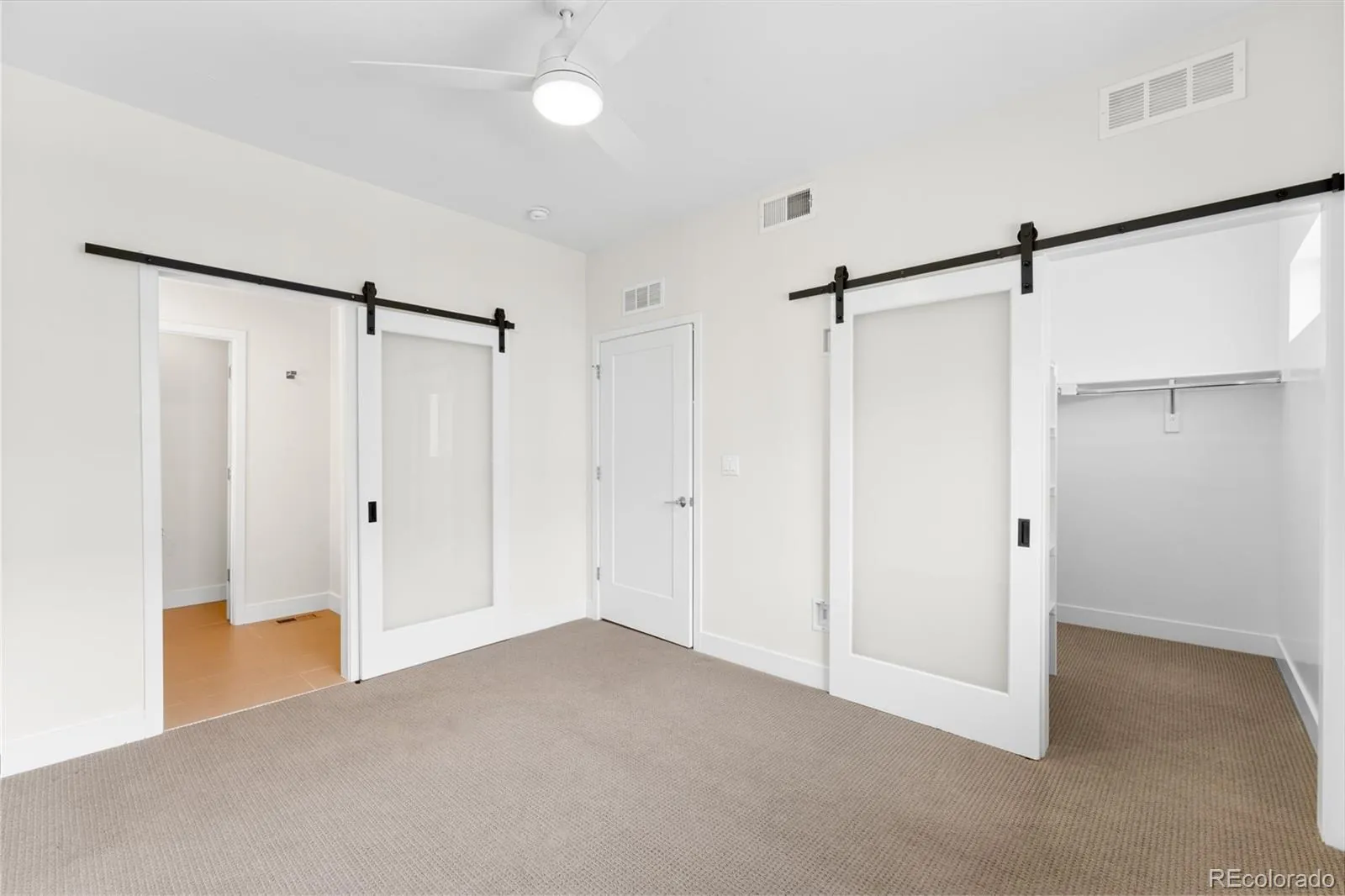 Bedroom with sliding barn doors at 1554 N Quitman Street